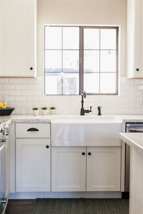 white cabinets with stainless steel farm sink|rustic backsplash with white cabinets.